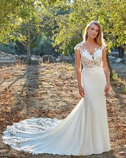 Bride outdoors standing amongst trees. Weddings in Northampton