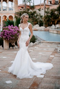 Bride by a swimming pool with purple flowers in the background. Weddings in Northampton.