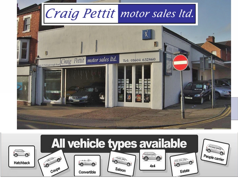 a car showroom with a banner saying Craig Pettit cars