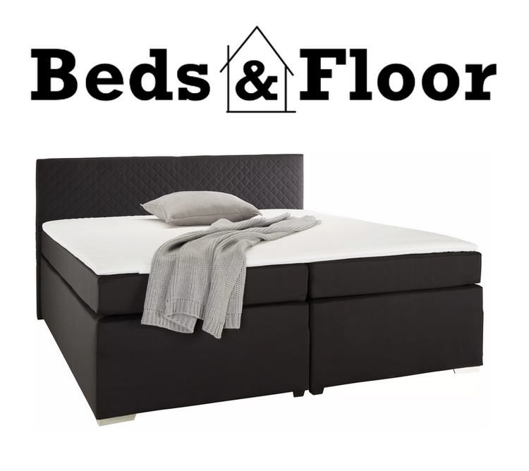 a double bed, black colour, with white sheets and a logo above.  Furniture in Northampton.