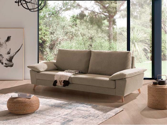 a settee with patio windows behind it and a rug in front. furniture shops in Northampton