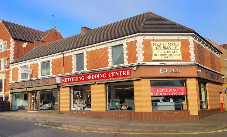 the front of a shop that sells bedding with a red sign over the windows.  Furniture in Kettering.