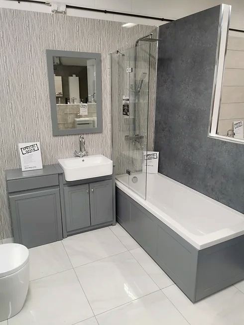 a display in a shop of a bathroom with a basin and a bath. Bathroom fitters in Northampton.