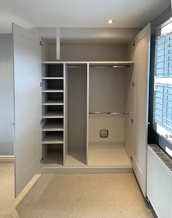 an empty fitted wardrobe with shelves on the left and hanging space to the right