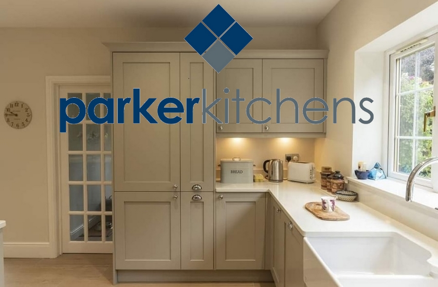 kitchen with cream units, a belfast sink, bread bin, kettle, and toaster on the worktop