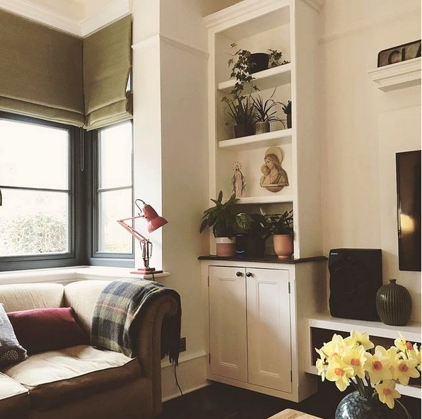 living room with built in cupboard and a sofa.