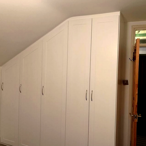 a fitted wardrobe in an attic