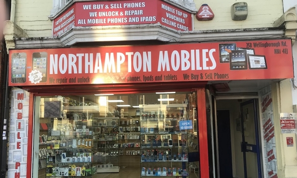 outside of a shop with a red facade saying Northampton mobiles